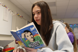 student reading book by Trevor Noah